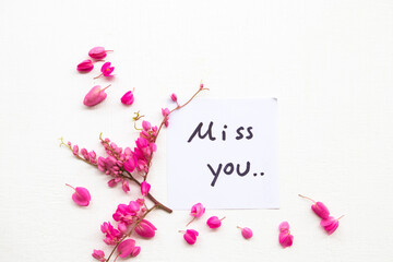 miss you message card handwriting with colorful little flowers arrangement flat lay postcard style on background white 