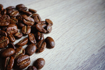 coffee beans on wooden table. roasted coffee beans, selective focus photo                                                          