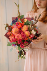 woman holding a gift bouquet of dahlias gladiolus spray rose
