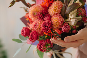 girl holding wonderful flowers in her hands
