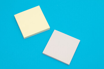 Stack of yellow paper stickers on blue background