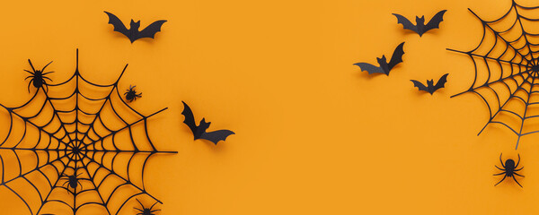 Halloween web banner. spider web and spiders made of paper on an orange background. Top view. Copy space