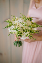 girl holding wonderful flowers in her hands
