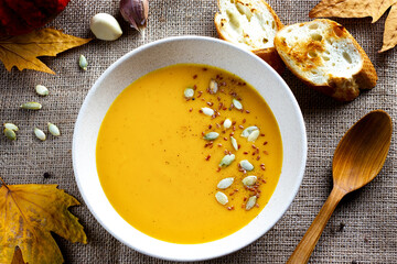Autumn dish. Cream soup, pumpkin porridge with seeds and toasted bread slices