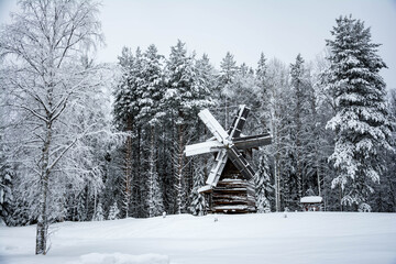 Old wooden windmill in the village Malye Korely near Arkhangelsk, Russia. Frosty winter day.