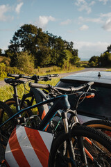 Fototapeta na wymiar Mountain bikes on a car bike rack. Cycling vacations.