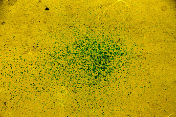 Yellow colored wall texture background with textures of different shades of yellow and dotted in the center