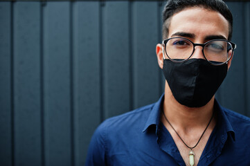 Middle eastern entrepreneur wear black face mask and eyeglasses. New normal life after coronavirus...