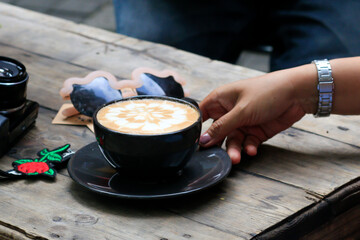 a cup of iced coffee latte on a wooden cafe table. brew fresh latte art coffee for coffee breaks during the day