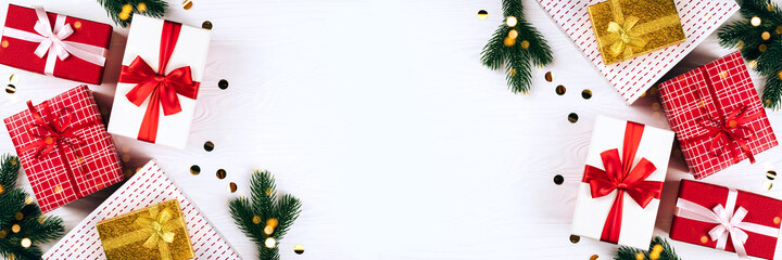 Banner made from festive gift boxes on wooden white background.