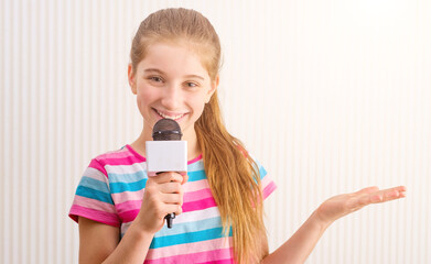 Little female blogger with microphone