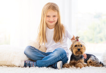 Sweet girlie sitting next to domestic dog