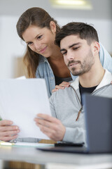 smiling interested businesswoman and businessman looking at documents