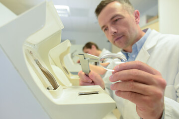 close up of a technician measuring lens