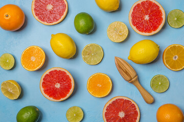 Orange, lemon, grapefruit, lime, mandarin different citrus fruits on a blue background, top view.