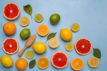 Orange, lemon, grapefruit, lime, mandarin different citrus fruits on a blue background, top view.