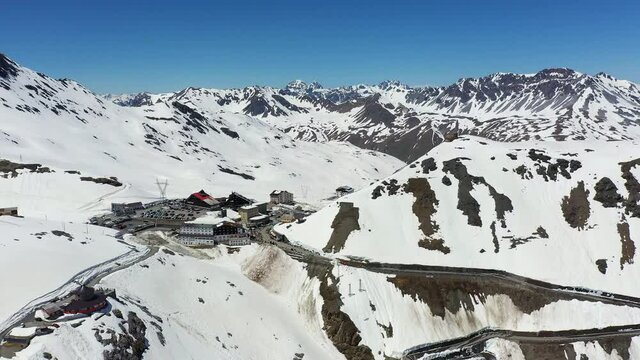 Aerial footage of the famous Stelvio pass in the alps in Italy with a backward and tilt up motion. 