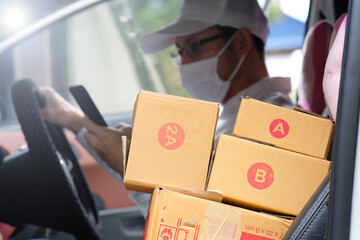 Delivery man holding a cardboad box and space for text and free delivery transport, Messenger and delivery concept