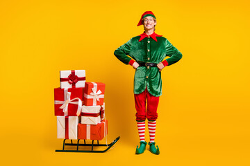 Full length body size view of his he nice attractive cheerful glad funny guy elf carrying giftboxes...
