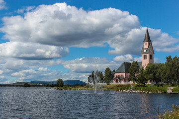 Fototapeta na wymiar Pink church by the lake in the Swedish town Arjeplog