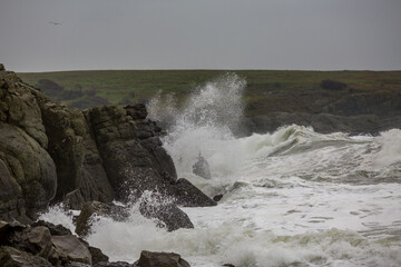 Dark moody autumn seascape landscape, stormy Black Sea, Bulgaria. Splashing sea waves and harsh cold windy weather