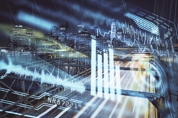 Double exposure of technology theme hologram and cityscape background. Concept of Hightech.