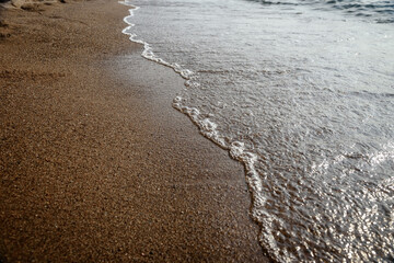 Wave on the sand beach background.