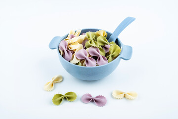 Butterfly noodles in a bowl of baby food supplement on white background