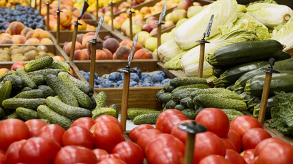 Variety fruits and vegetables on store shelves. Grocery department of supermarket, no people.