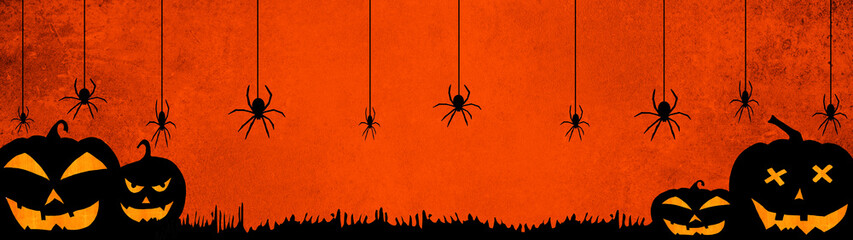 HALLOWEEN background banner wide panoramic panorama template -Silhouette of scary carved luminous cartoon pumpkins and spiders isolated on dark orange red night texture