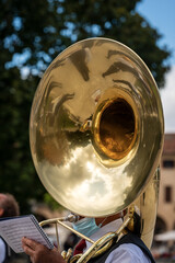 Close-up of a musician of a brass band playing the Tuba Sousaphone during a city festival in the...