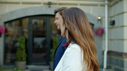 Fototapeta premium Cheerful business couple walking outdoors. Happy partners walking to office