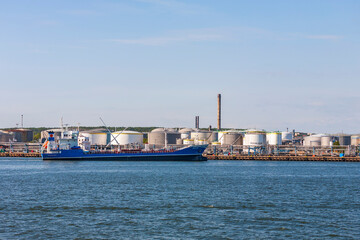 Fototapeta na wymiar Oil terminal with a ship on its way to the harbour