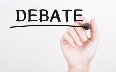 Hand writing DEBATE with black marker on transparent wipe board