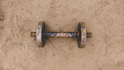 Dumbbell on the sand. equipment for weight lifting