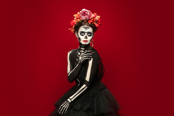 Scary. Young girl like Santa Muerte Saint death or Sugar skull with bright make-up. Portrait...