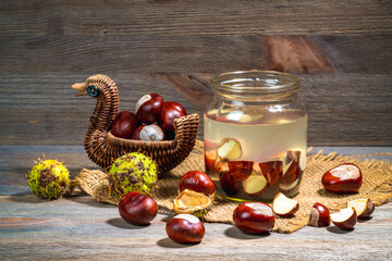 Preparation of alcohol tincture from fresh horse chestnuts. Chestnuts in a jar of alcohol