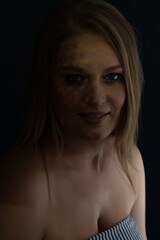 Beautiful mid adult woman with interesting pattern of light on her face and body. Beauty female portrait.