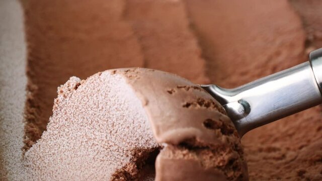 scooping Ice cream Chocolate out from container with a spoon. Food concept, Blank for design.