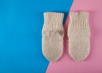 Winter warm socks on an isolated pink and blue background.