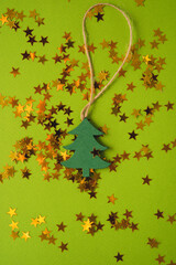 Christmas wooden toy on a green background,  the concept of a New year