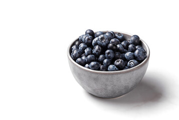 Bowl of fresh ripe blueberries on a white marble background. Healthy seasonal fruit. Organic food blueberries for healthy lifestyle and eating. Vegan, vegetarian concept. Rustic.