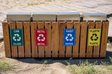 Separate collection of waste on the turkish beach: glass, metal, paper, plastic