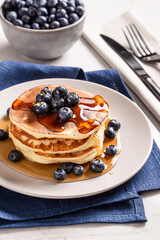 American breakfast. Stack of homemade american pancakes with fresh berry and pouring maple syrup on a white background. Fresh blueberries. Food photo. Breakfast photo. Recipe. Fluffy. Close up view