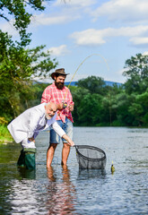 Family traditions. Two male friends fishing together. happy fishermen. Good profit. fly fish hobby of businessman. retirement fishery. Catching and fishing concept. retired dad and mature bearded son