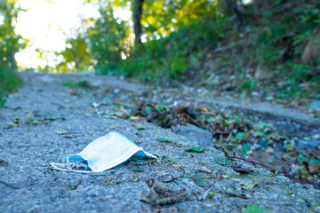 Surgical mask thrown into the environment