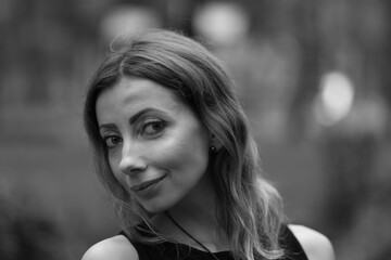 Portrait of beautiful woman outside in black and white