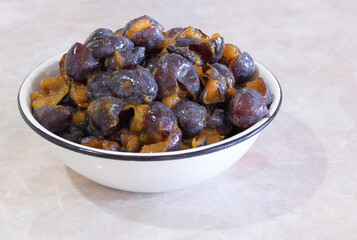 Plums in a bowl with the seeds removed. In the process of making jam