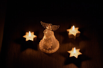Christmas angel and candles on a dark background