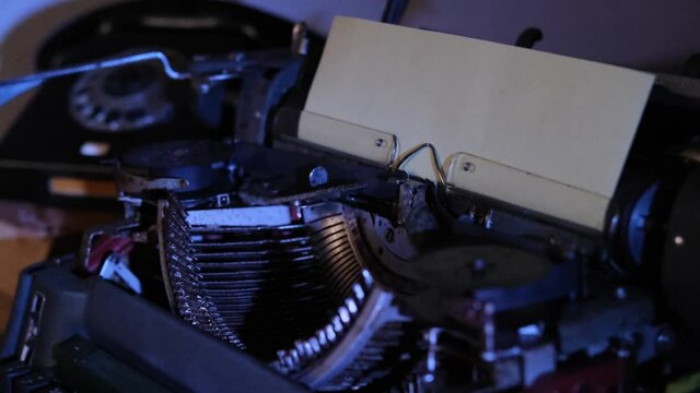 old typewriter on desk, telephone, mystery detective concept, writer's work tools, blue backlight